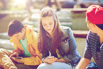 Image showing teenage friends with smartphones outdoors