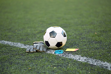 Image showing ball, gloves, whistle and cards on soccer field