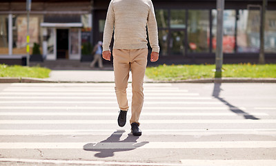 Image showing senior man walking along city crosswalk