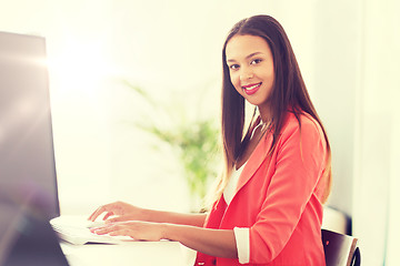 Image showing happy african woman with computer at office