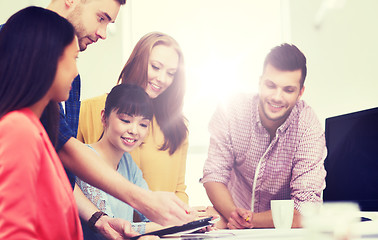 Image showing happy creative team with tablet pc at office