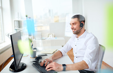 Image showing businessman with headset and computer at office