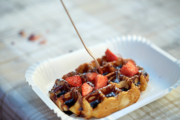 Image showing waffle with strawberry on paper plate and fork