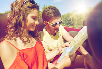 Image showing happy friends driving in cabriolet car