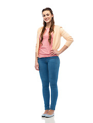 Image showing happy smiling young woman in cardigan and jeans