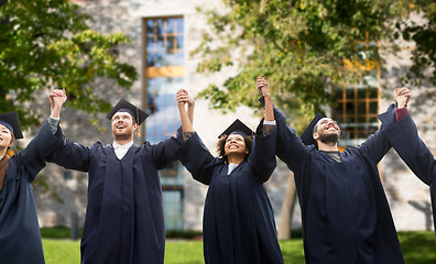 Image showing happy students or bachelors celebrating graduation