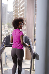 Image showing afro american woman running on a treadmill