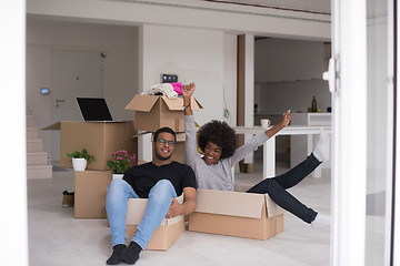 Image showing African American couple  playing with packing material