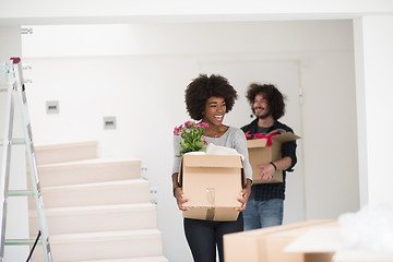 Image showing multiethnic couple moving into a new home