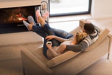 Image showing Young couple  in front of fireplace