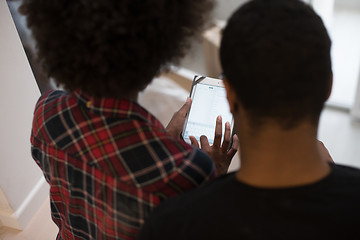 Image showing african american couple using tablet at home