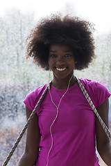 Image showing portrait of young afro american woman in gym while listening mus