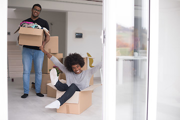 Image showing African American couple  playing with packing material