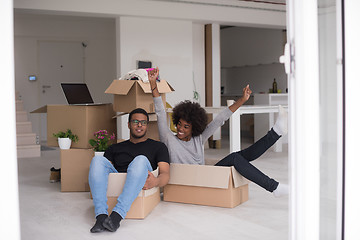 Image showing African American couple  playing with packing material