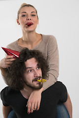 Image showing couple in party hats blowing in whistle