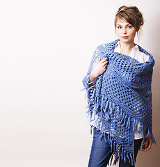 Image showing pretty young blond real woman with wool wrap in studio on white 