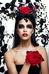 Image showing pretty brunette woman with rose jewelry, black and red, bright m