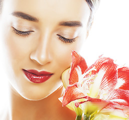 Image showing young pretty brunette woman with red flower amaryllis close up i