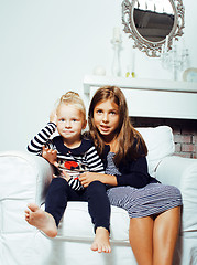 Image showing two cute sisters at home interior playing, little happy smiling 