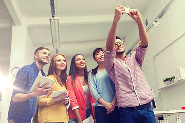 Image showing creative business team taking selfie at office