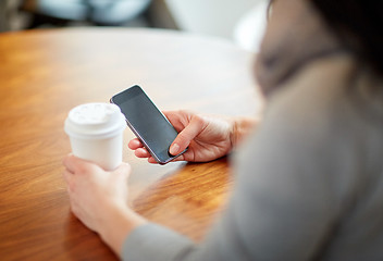 Image showing close up of woman with smartphone and coffee at cafe