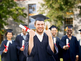 Image showing happy student with diploma celebrating graduation