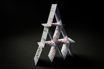 Image showing house of playing cards over black background