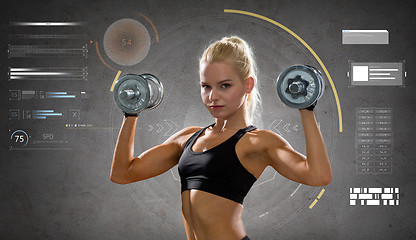 Image showing happy young sporty woman exercising with dumbbells