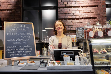 Image showing happy woman or barmaid at cafe counter