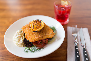 Image showing close up of fish salad with roasted lemon on plate