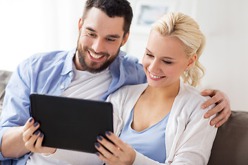 Image showing smiling happy couple with tablet pc at home