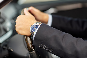 Image showing senior businessman hands driving car