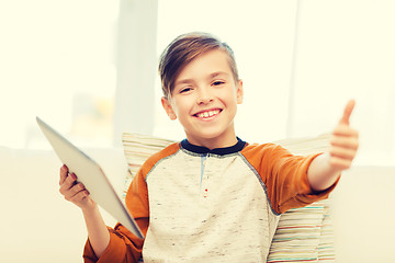 Image showing smiling boy with tablet showing thumbs up at home