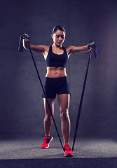 Image showing woman with expander exercising in gym