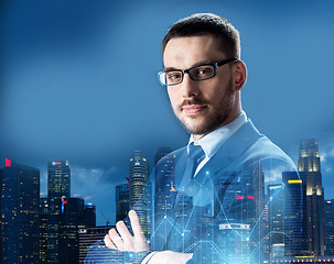 Image showing businessman in glasses over night singapore city