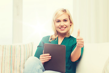 Image showing smiling woman with tablet pc at home