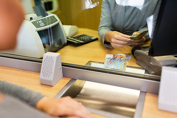 Image showing clerk counting cash money at bank office