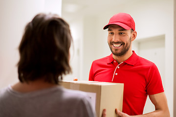 Image showing happy delivery man giving parcel box to customer