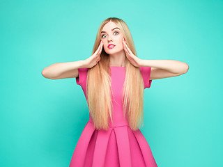 Image showing The beautiful young woman in pink mini dress posing at studio