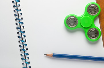 Image showing Fidget spinner on notepad