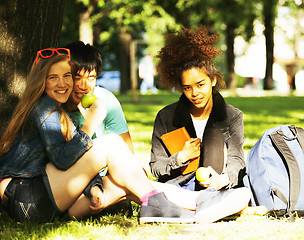 Image showing cute group of teenages at the building of university with books 