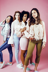 Image showing different nation girls with diversuty in skin, hair. Asian, scandinavian, african american cheerful emotional posing on pink background, woman day celebration, lifestyle people concept