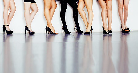 Image showing diverse type pair of woman legs in hight heels black shoes isolated on white background and floor, diversity people lifestyle concept