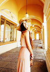 Image showing young pretty smiling woman in hat with bags on shopping at store