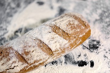 Image showing Fully baked bread on flour