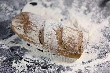 Image showing Fully baked bread on flour