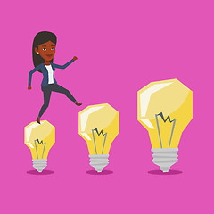 Image showing Business woman jumping on idea light bulbs.