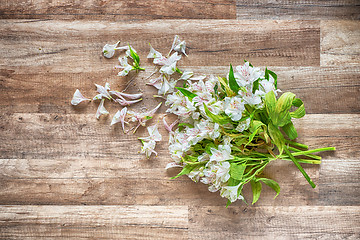 Image showing withered flowers on the wooden floor