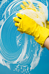 Image showing Window cleaner in yellow gloves