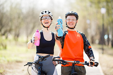 Image showing Bicyclists with bottles of water